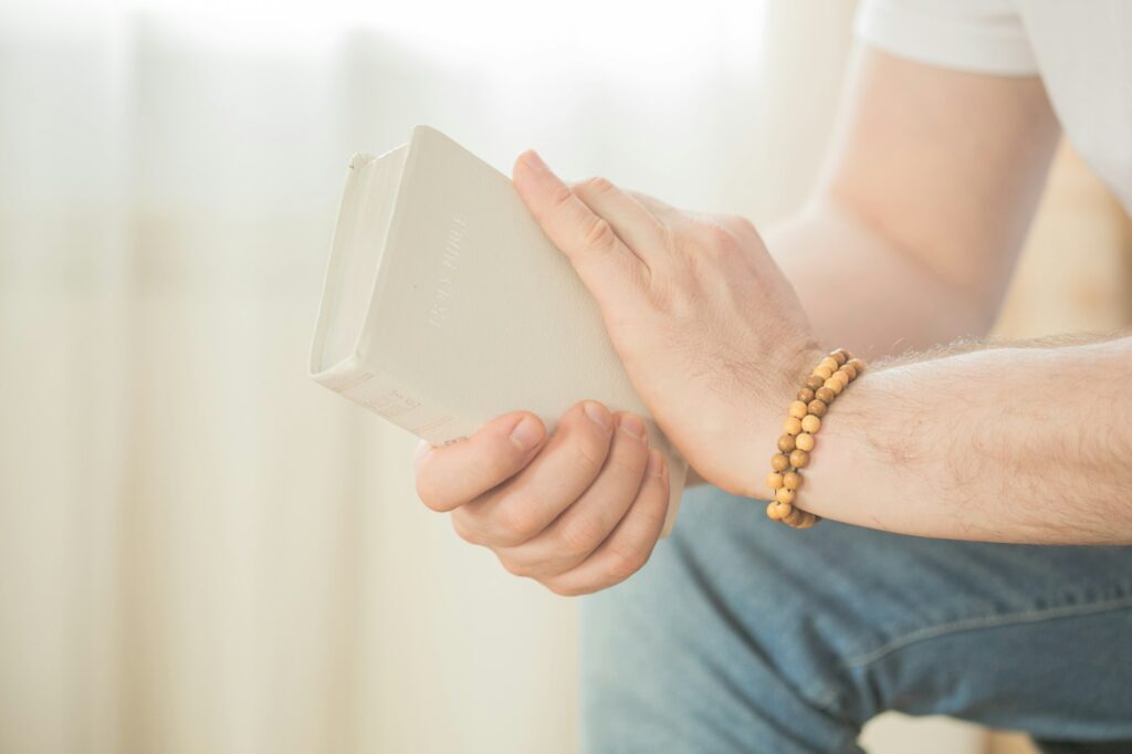 The Christian holds the Bible in his hands. Reading the bible.